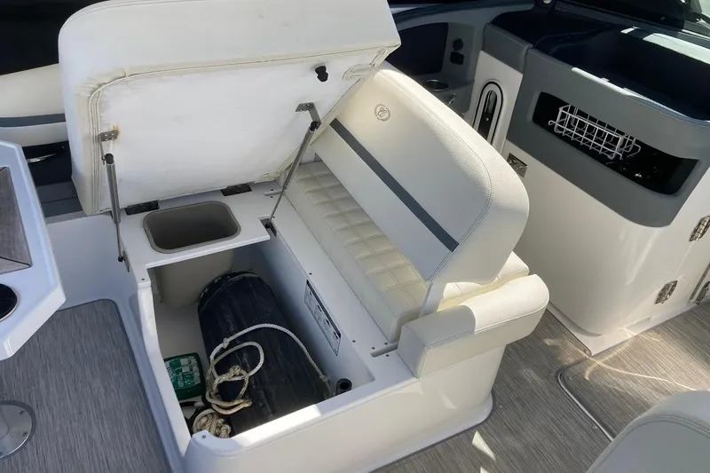 Slide: The Image of 2022 Cobalt R30 boat interior with open storage compartment and seating. - 21