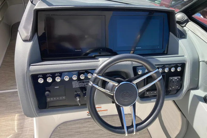 Slide: The Image of 2022 Cobalt R30 boat dashboard with dual Garmin screens and steering wheel. - 23