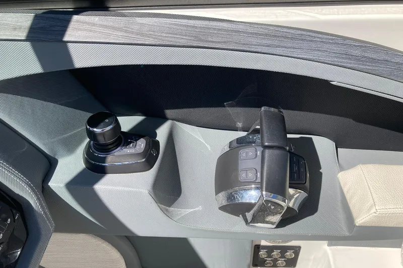 Slide: The Image of Control panel of a 2022 Cobalt R30 boat with joystick and throttle. - 24
