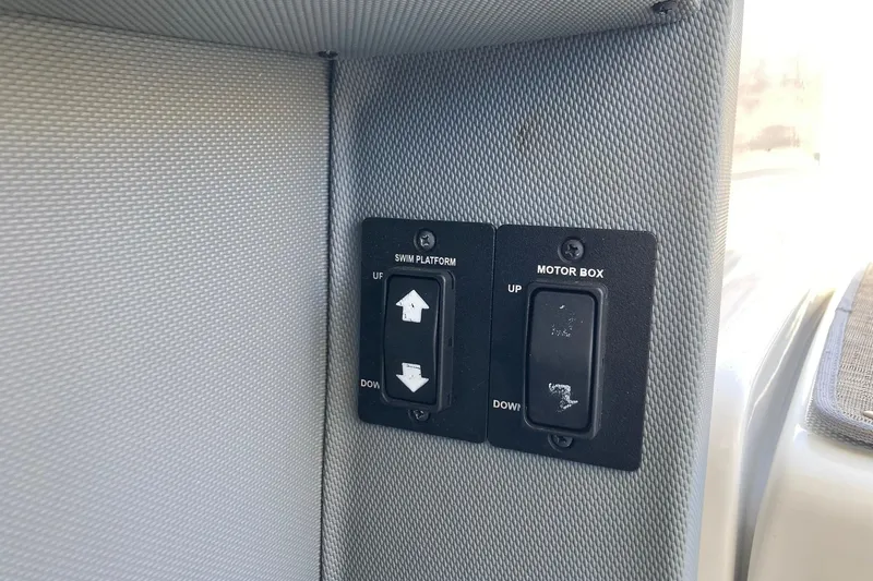 Slide: The Image of Control panel on 2022 Cobalt R30 boat for swim platform and motor box adjustments. - 25