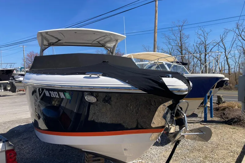 Slide: The Image of 2022 Cobalt R30 boat with cover, parked outdoors on a sunny day. - 3