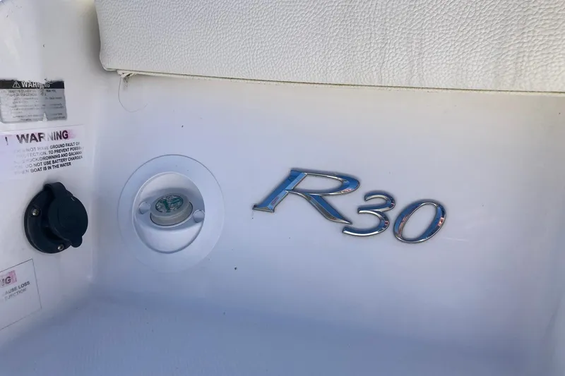 Slide: The Image of 2022 Cobalt R30 boat interior with logo and warning labels. - 33