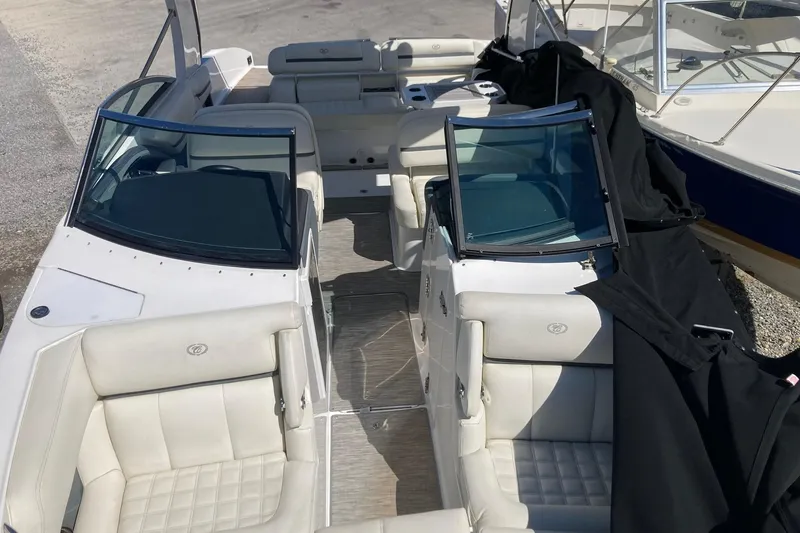 Slide: The Image of 2022 Cobalt R30 boat interior with white leather seating and glass windshields. - 7