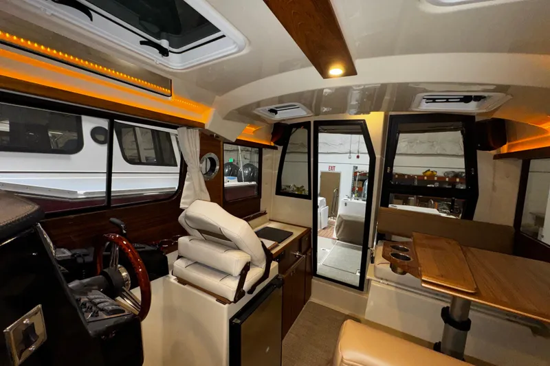 Slide: The Image of Interior of 2026 Ranger Tugs R-25 boat with modern design and wood accents. - 10