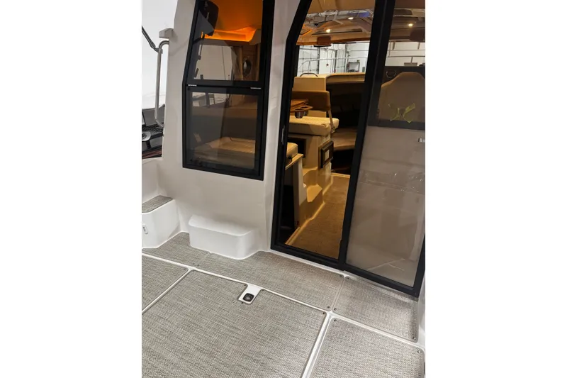 Slide: The Image of Interior view of 2026 Ranger Tugs R-25 boat, featuring modern design and cozy seating. - 5