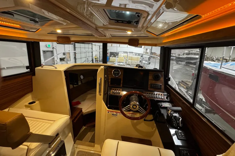 Slide: The Image of Interior view of 2026 Ranger Tugs R-25 boat cockpit with modern controls and seating. - 7