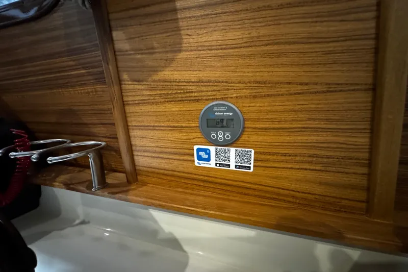 Slide: The Image of Control panel on 2026 Ranger Tugs R-25 boat with wood finish and QR codes. - 8