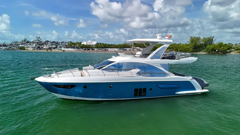 The Image of Azimut 50 Flybridge 2016 yacht on calm water under a partly cloudy sky. - 0