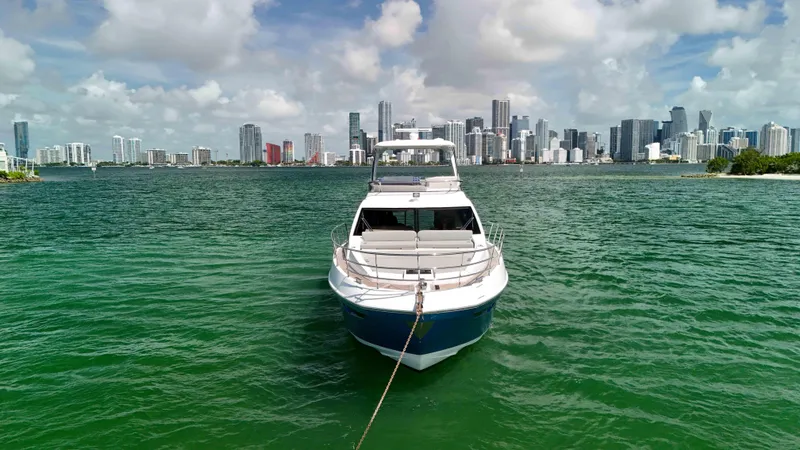 Slide: The Image of Azimut 50 Flybridge 2016 yacht on water with city skyline in background. - 11