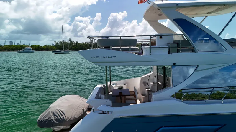 Slide: The Image of 2016 Azimut 50 Flybridge yacht on serene water with clear skies. - 17