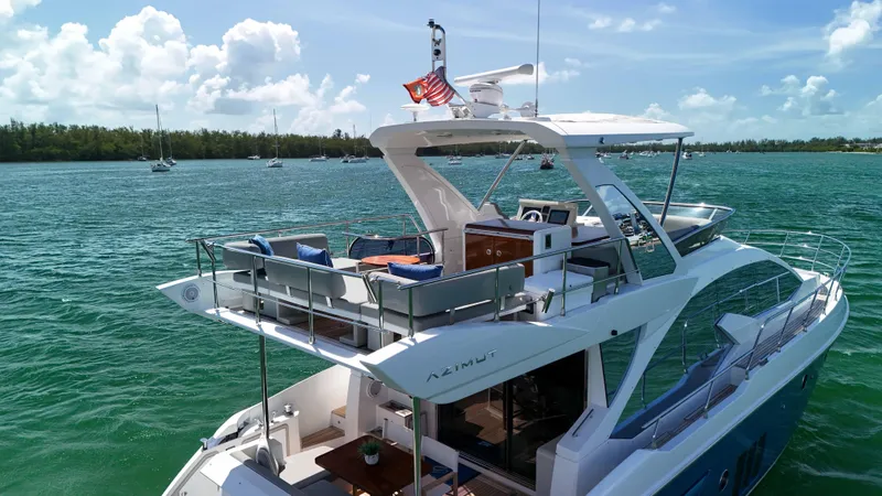 Slide: The Image of 2016 Azimut 50 Flybridge yacht cruising on a sunny day with clear skies. - 19