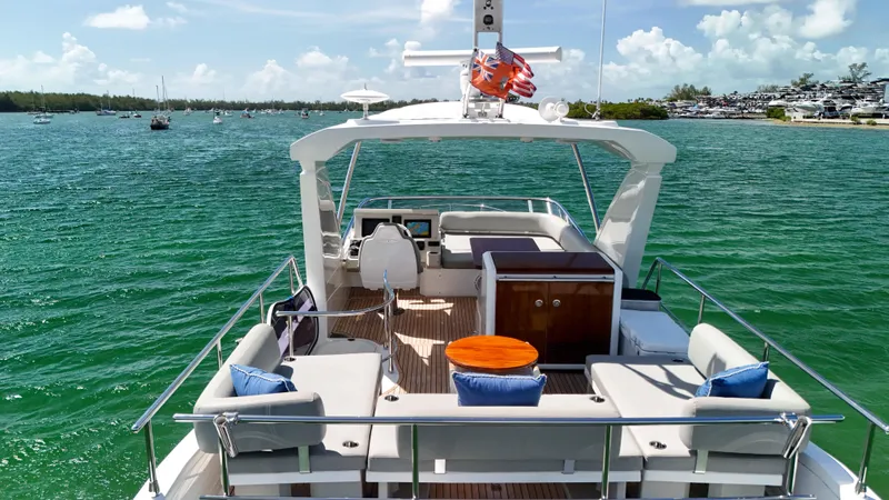 Slide: The Image of Azimut 50 Flybridge 2016 yacht on serene water, featuring spacious deck and luxurious seating. - 21