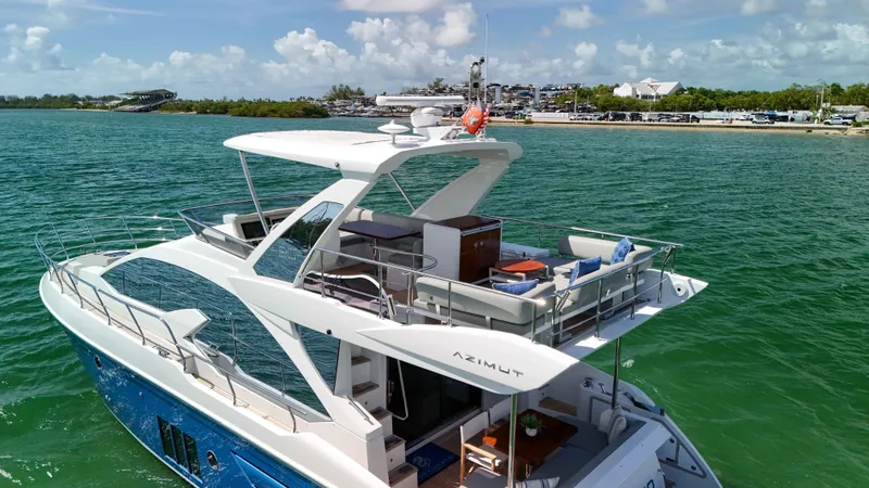 Slide: The Image of 2016 Azimut 50 Flybridge yacht cruising on clear blue waters. - 23