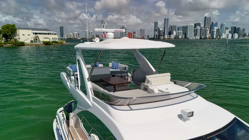 Slide: The Image of 2016 Azimut 50 Flybridge yacht on water with city skyline in background. - 28