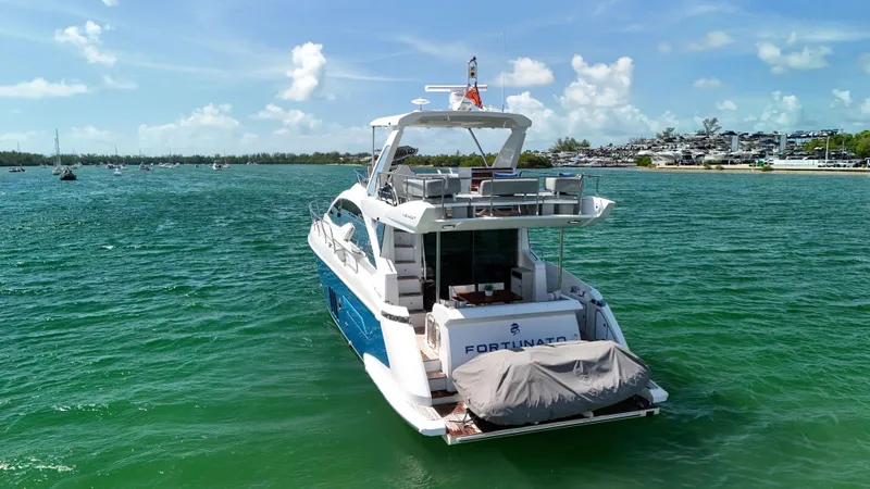 Slide: The Image of Azimut 50 Flybridge 2016 yacht on serene water with clear skies. - 3