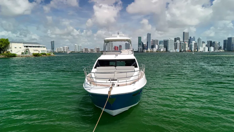 Slide: The Image of 2016 Azimut 50 Flybridge yacht anchored with city skyline in background. - 30