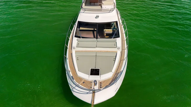 Slide: The Image of 2016 Azimut 50 Flybridge yacht on vibrant green water, aerial view. - 31