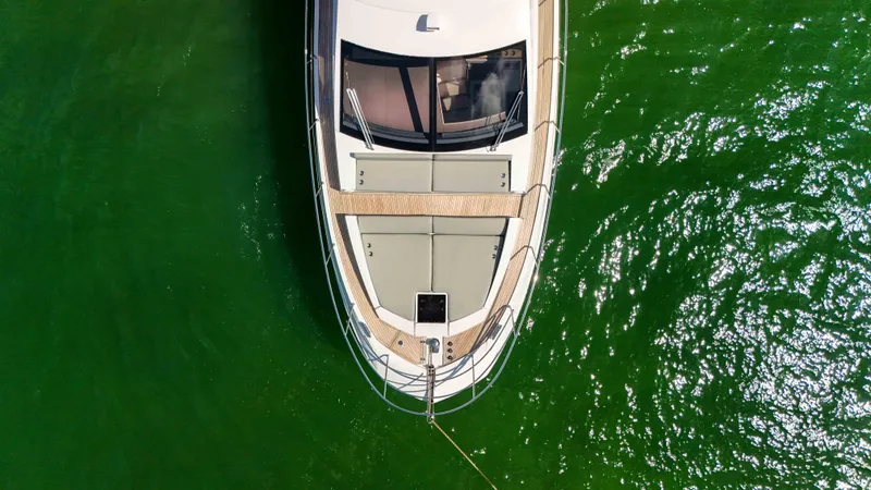 Slide: The Image of Overhead view of 2016 Azimut 50 Flybridge yacht on green water. - 33