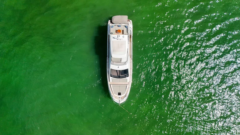 Slide: The Image of Overhead view of 2016 Azimut 50 Flybridge yacht on vibrant green water. - 34