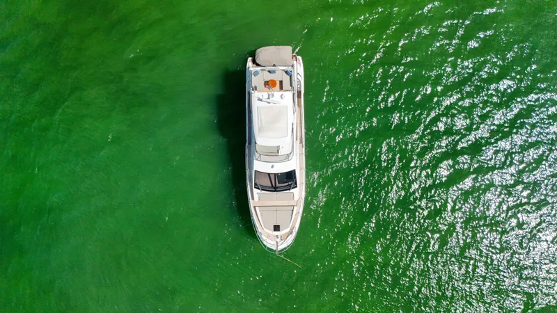 Slide: The Image of Aerial view of 2016 Azimut 50 Flybridge yacht on vibrant green water. - 35