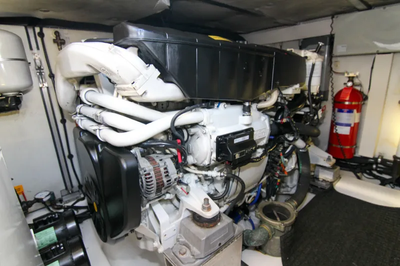 Slide: The Image of Engine room of 2016 Azimut 50 Flybridge yacht, featuring complex machinery and fire extinguisher. - 39