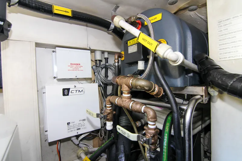 Slide: The Image of Engine room of 2016 Azimut 50 Flybridge yacht, featuring complex piping and equipment. - 43