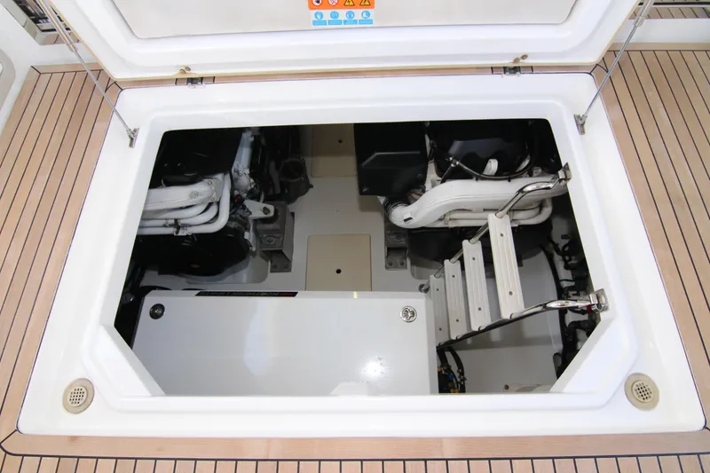 Slide: The Image of Engine compartment of 2016 Azimut 50 Flybridge yacht, showcasing mechanical components and access ladder. - 44