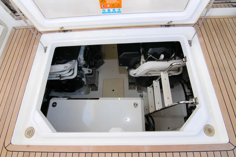 Slide: The Image of Engine compartment of 2016 Azimut 50 Flybridge yacht, showcasing mechanical components and ladder. - 45
