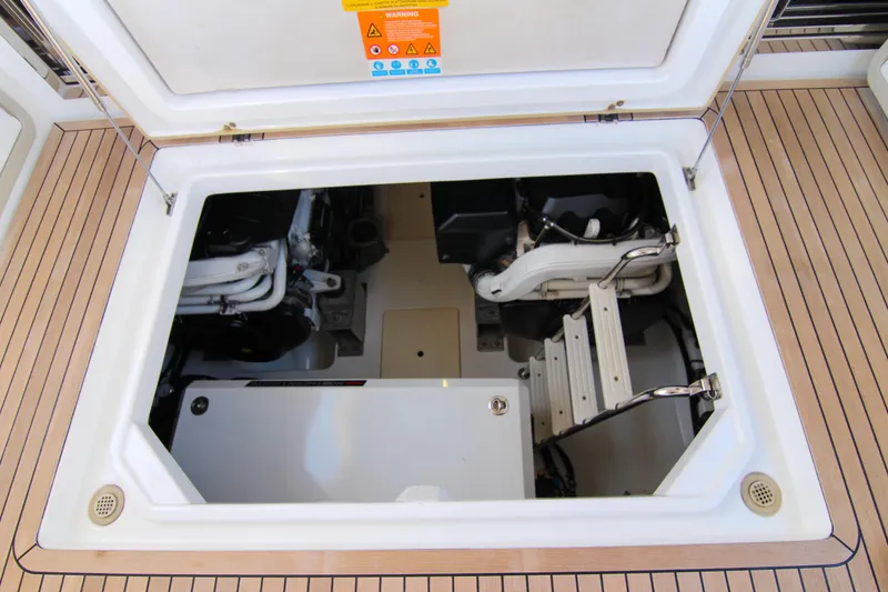 Slide: The Image of Engine compartment of 2016 Azimut 50 Flybridge yacht, showcasing mechanical components and access ladder. - 46