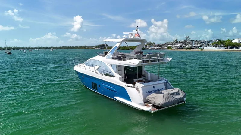 Slide: The Image of Azimut 50 Flybridge 2016 yacht on turquoise water under a clear blue sky. - 5