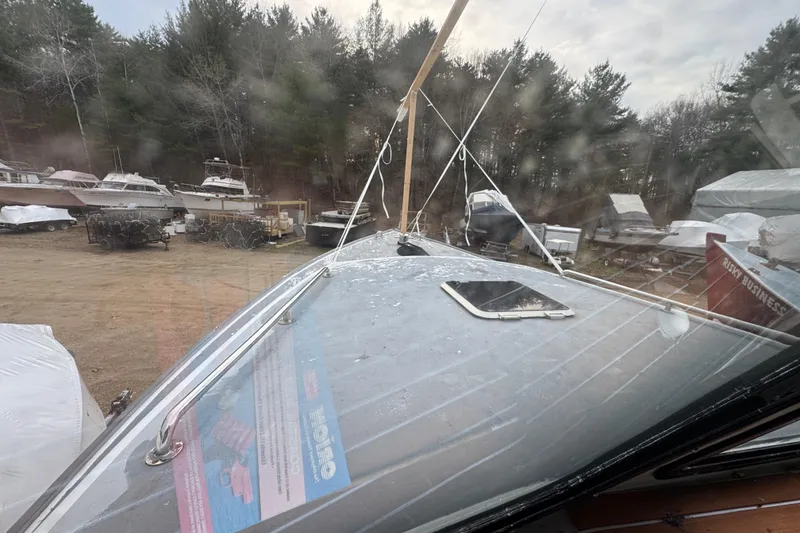 Slide: The Image of 2007 Northern Bay 36 boat in storage yard, surrounded by trees and other boats. - 16