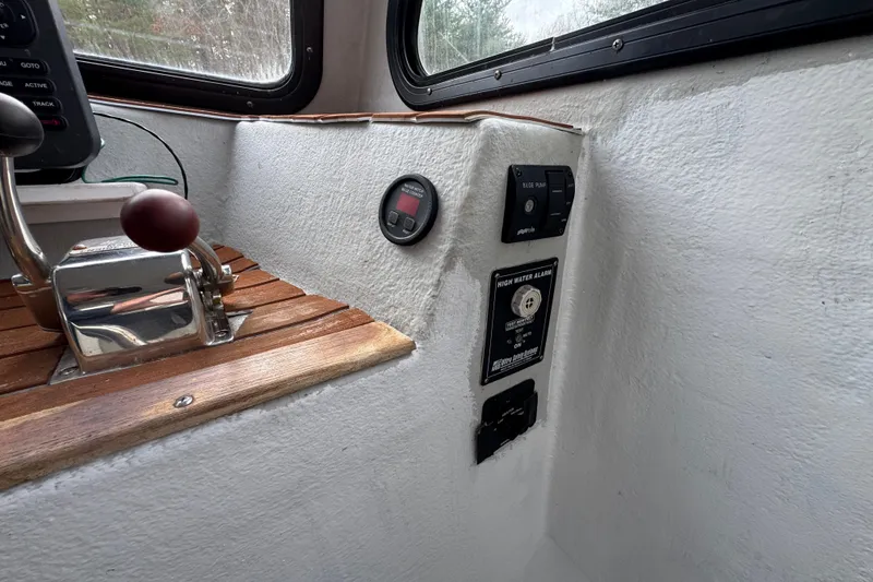Slide: The Image of Control panel of a 2007 Northern Bay 36 boat with throttle and high water alarm. - 17
