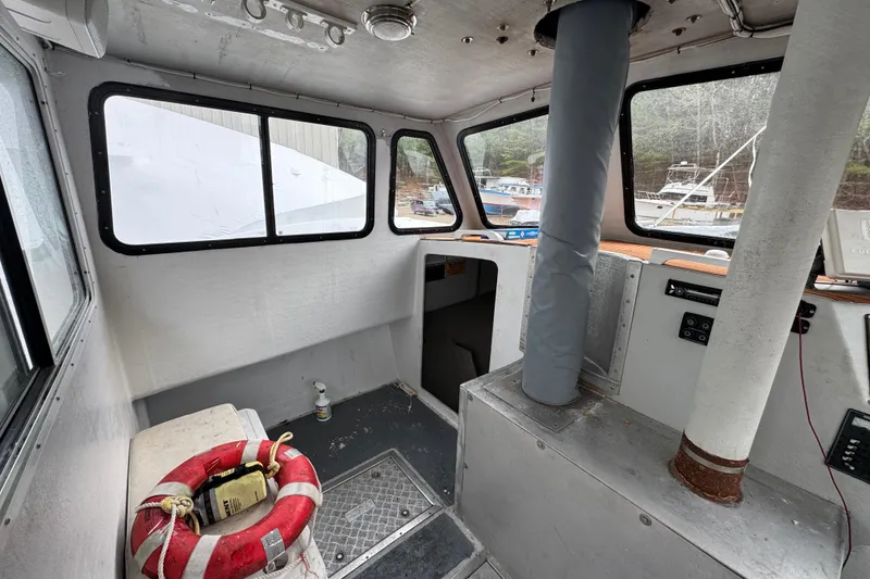 Slide: The Image of Interior of a 2007 Northern Bay 36 boat, featuring windows and safety equipment. - 27