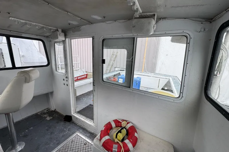Slide: The Image of Interior of a 2007 Northern Bay 36 boat, featuring a white seat and life preserver. - 28