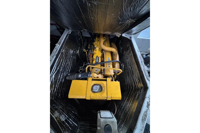 Slide: The Image of Engine compartment of a 2007 Northern Bay 36 boat, featuring a yellow engine. - 32