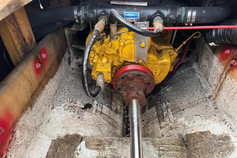 Slide: The Image of Engine compartment of a 2007 Northern Bay 36 boat, featuring mechanical components and hoses. - 34