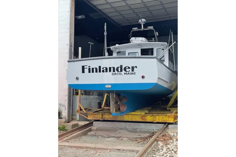 Slide: The Image of 2007 Northern Bay 36 boat on dry dock, showing hull and rudder, surrounded by trees. - 4