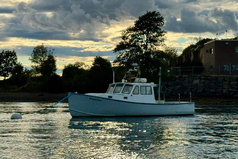 Slide: The Image of 2007 Northern Bay 36 boat anchored on calm water at sunset. - 40