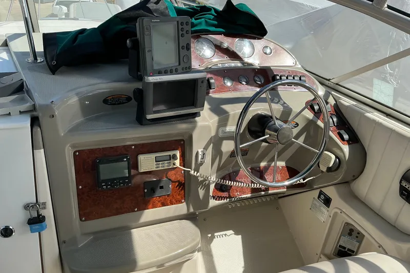 Slide: The Image of Cockpit of 1997 Maxum 2700 SCR boat with steering wheel and navigation equipment. - 11