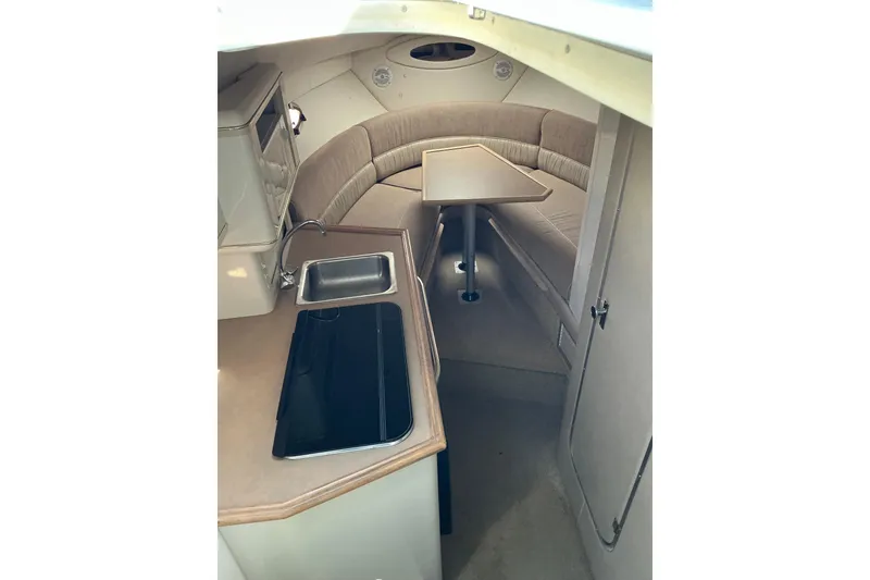Slide: The Image of Interior of 1997 Maxum 2700 SCR boat with kitchenette and seating area. - 14