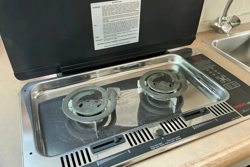 Slide: The Image of Built-in stove on 1997 Maxum 2700 SCR boat, featuring dual burners and control panel. - 16