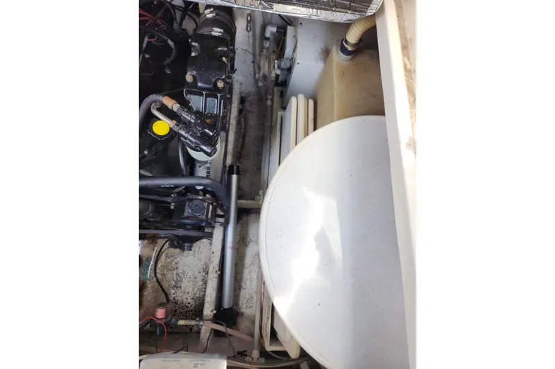 Slide: The Image of Engine compartment of a 1997 Maxum 2700 SCR boat, showing mechanical components. - 23