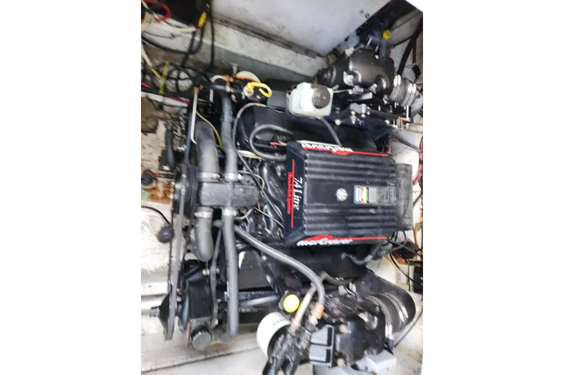 Slide: The Image of Engine of a 1997 Maxum 2700 SCR boat, showcasing mechanical components and wiring. - 24