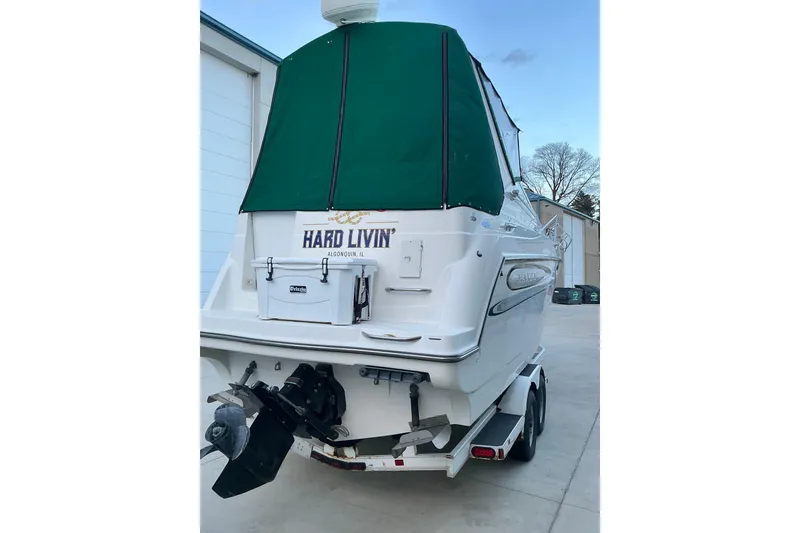 Slide: The Image of 1997 Maxum 2700 SCR boat with green canopy on trailer, rear view. - 4