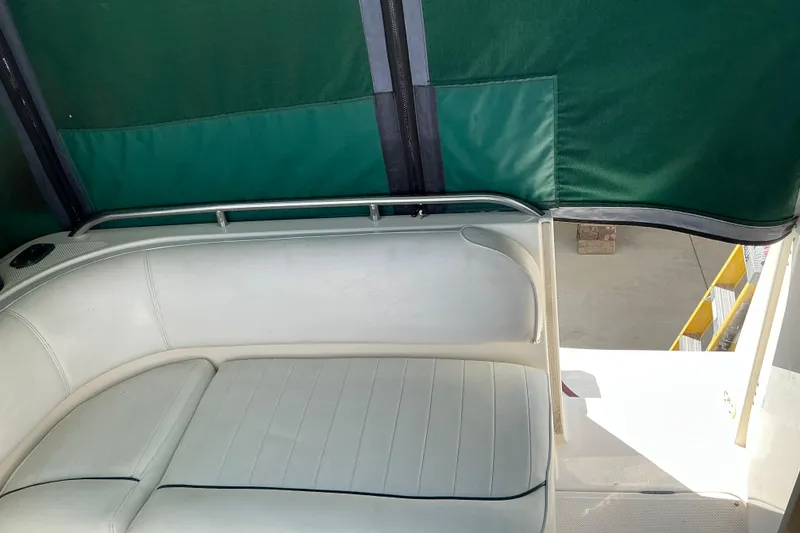 Slide: The Image of Interior seating of 1997 Maxum 2700 SCR boat with green canopy. - 7