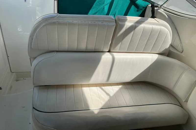 Slide: The Image of White leather seating on a 1997 Maxum 2700 SCR boat interior. - 8