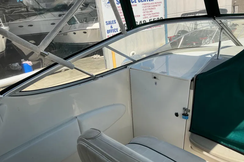 Slide: The Image of Interior view of a 1997 Maxum 2700 SCR boat cockpit with seating and storage. - 9