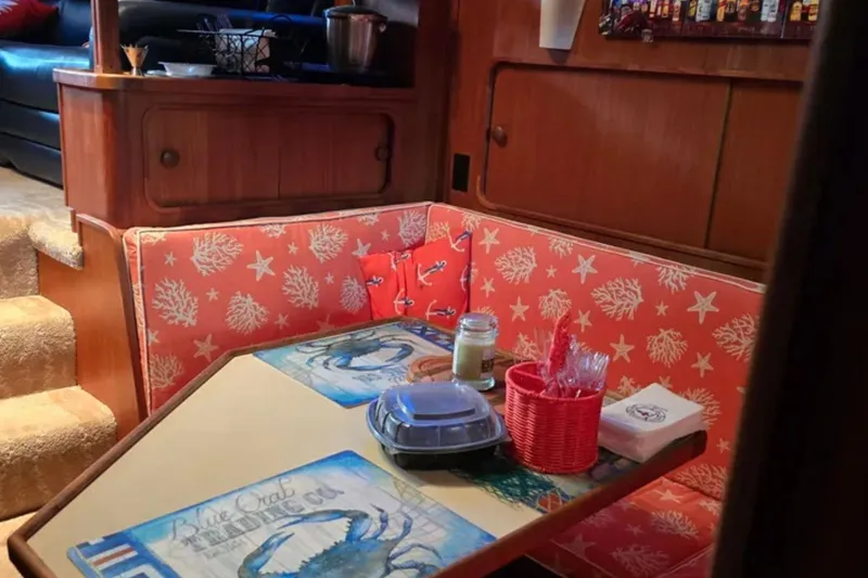 Slide: The Image of Cozy dining area in 1987 Chris-Craft 427 Catalina with nautical-themed decor. - 12