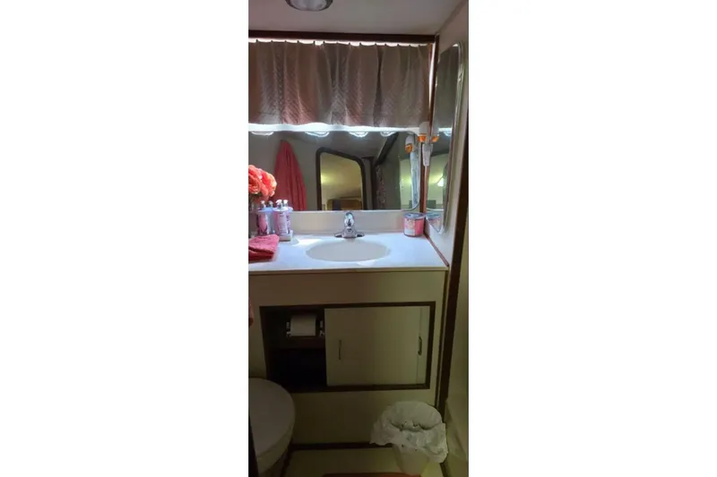 Slide: The Image of Bathroom interior of 1987 Chris-Craft 427 Catalina yacht, featuring sink and mirror. - 14