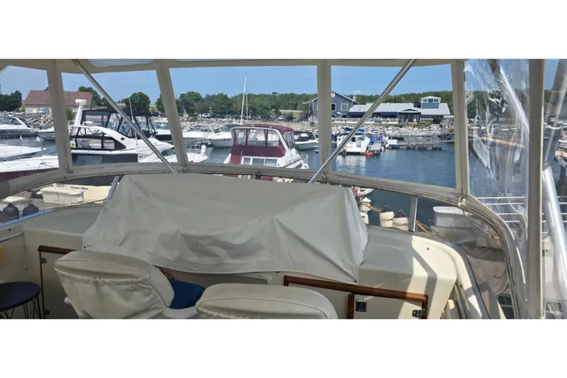 Slide: The Image of 1987 Chris-Craft 427 Catalina yacht interior view at marina with multiple boats docked. - 4